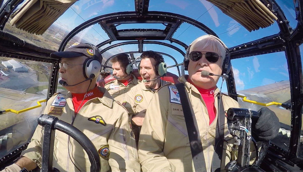 Lancaster crew and passenger in the cockpit during a flight